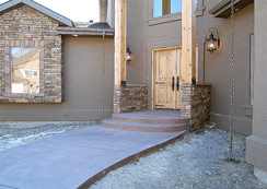 Huge timber post that extend up to the roof line, wide walkway with colored concrete... 