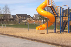 Jungle gym at school playground, home in distance...